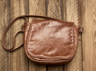 brown leather bag on gray wooden background