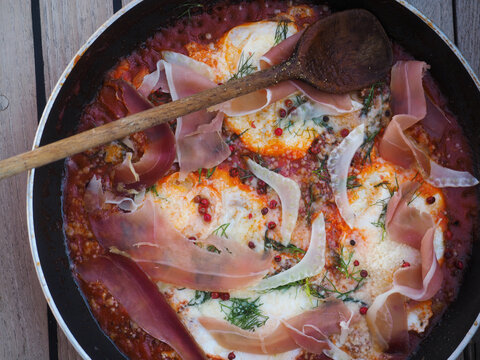 Fried egg with ham, tomato sauce, herbs and spices, eastern style