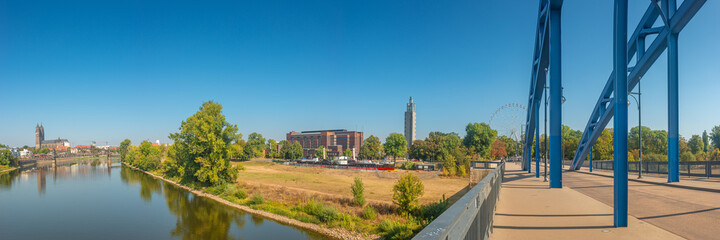 Naklejka na ściany i meble Panoramic view over downtown of Magdeburg, old town, Elbe river, bridges and Magnificent Cathedral at early Autumn, Germany, at sunny day and clear blue sky...