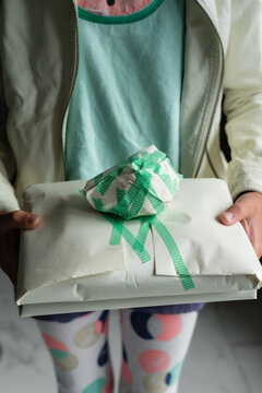tween girl holding a present she wrapped herself