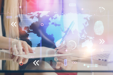 Multi exposure of hands making notes with world map hologram and data theme icons. Concept of global computer data.