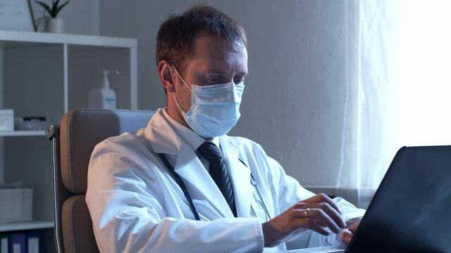 Professional medical doctor working in hospital using computer.