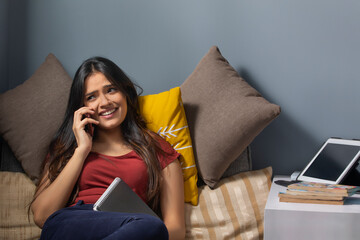Woman talking on the phone with a diary in her hand	