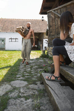 Bearded man working in romanian traditional household