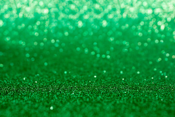 Christmas xmas or New Year Eve background. green abstract background with selective focus in the middle. Green glitter bokeh vintage lights, Happy holiday new year, defocused.