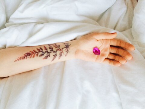Close up of hand with fern tattoo