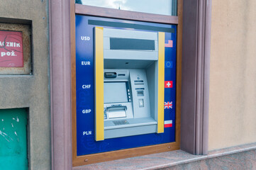 ATM machine on wall. Automated teller machine on the wall with currency codes USD, EUR, CHF, GBP...