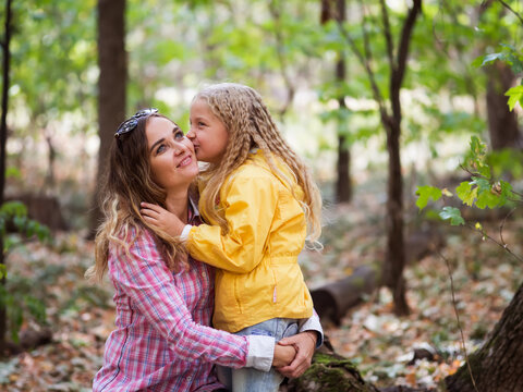 Loving young mother, having fun in nature with her child, in the fall. Emotion concept. Psychology.