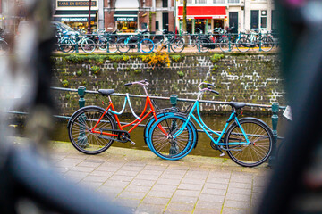 Fototapeta na wymiar Two bicycles near canal around the center of Amsterdam , Netherlands