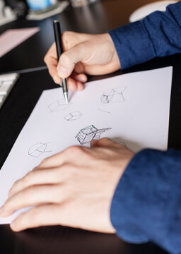 Hands drawing an idea on paper.