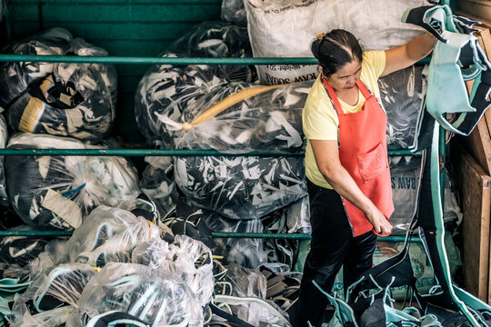 Woman Sorting Through Scrap Carseat Foam to Repurpose as Doormat