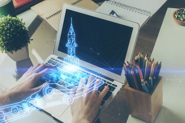 Start up drawings with businessman working on computer on background. Teamwork concept. Double...