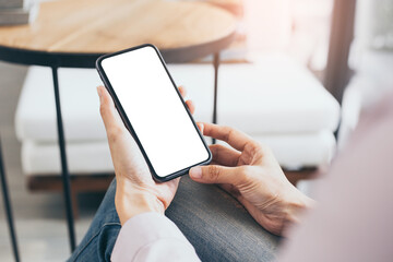 cell phone mockup blank white screen.woman hand holding texting using mobile on desk at coffee shop.background empty space for advertise.work people contact marketing business,technology