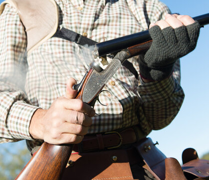 Open and smoking shotgun after taking the used cartridges after a shot