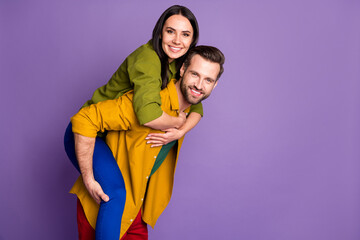 Obraz premium Profile photo pretty lady handsome guy couple carry piggyback meet adventures playful mood spend time quarantine wear casual bright shirts pants outfit isolated purple color background