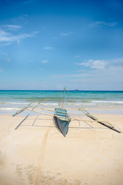 Traditional Philippines fishing boat with outriggers, often known as vanca or bangka.