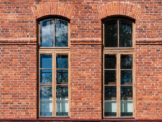 Fototapeta na wymiar Beautiful high Windows in an old brick building.