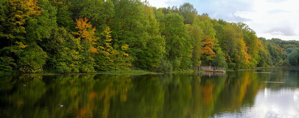 Autumn sunset on the lake with colorful colorful trees