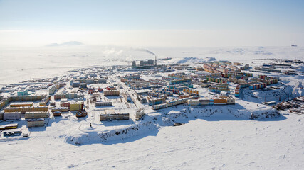 Winter panorama of the northern city of Anadyr. Aerial view of a snow-covered arctic town in the...