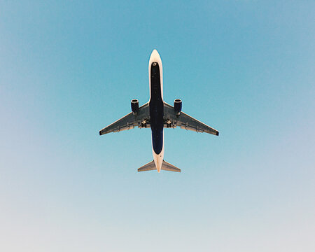 Underbelly of an Overhead Plan Against a Blue Sky.