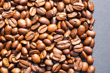 Brown roasted coffee beans seed on dark background