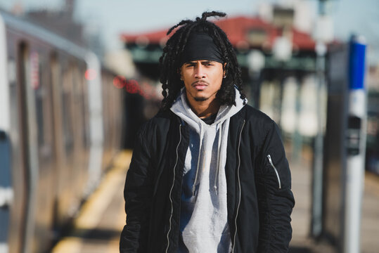 Young man by the train in the city