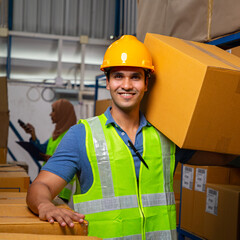 Warehouse worker holding a carton on shoulder