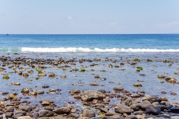 View on Indian ocean coast with pebble and sand beach on Bali, Indonesia
