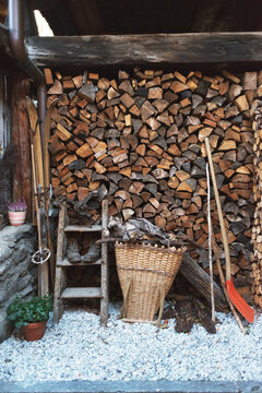 Stacked firewood - pile of chopped fire wood logs. Rural home concept.
