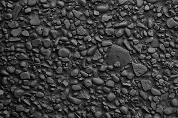 dark gray  wall decorated with small stones