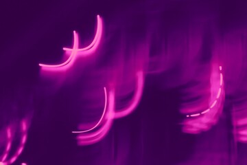 blurry purple and pink bright light stripes in night