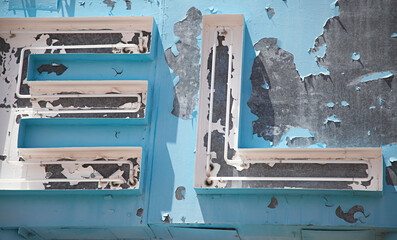 Close up of old neon sign with peeling paint