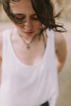 Closeup Lifestyle Photo of Woman / Girl with her Hair Blowing in the Wind Outdoors