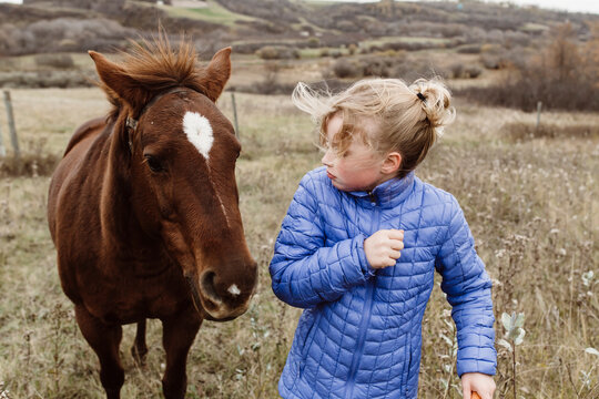 Young girl scared of horse