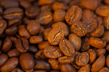 Mixture of different kinds of roasted coffee beans background.