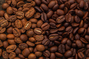 Mixture of different kinds of roasted coffee beans background.