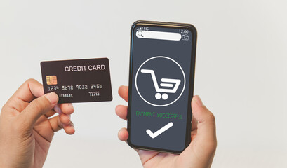 A man is using mobile smart phone for buying ,shopping  online and make a payment by a credit card.