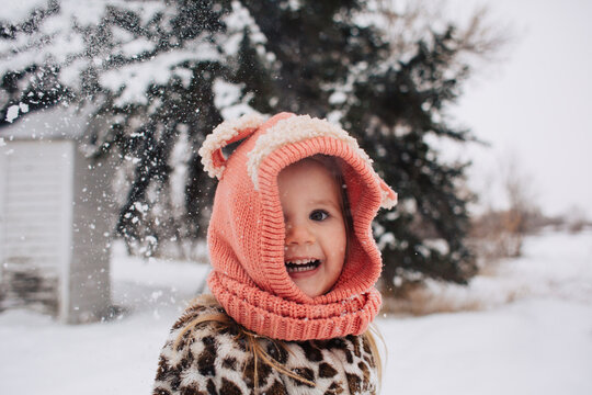 Toddler Girl Throwing Snow At Camera