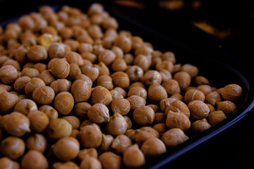 Orange lentils, white beans, peas in dark plates