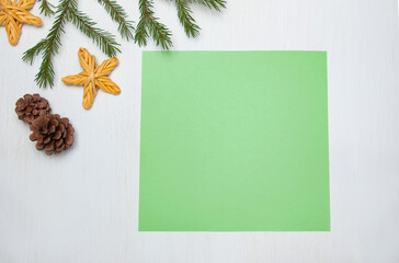 Green sheet of paper and New Year's baubles on a light background. Step 1: How to create bookmarks...
