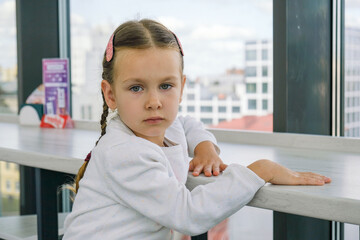 
A little girl sits at the bar and waits for her order