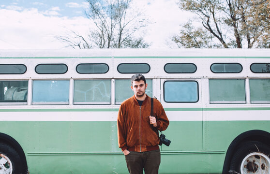 photographer standing behind a bus