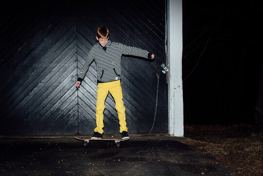 teen with yellow trousers on skateboard