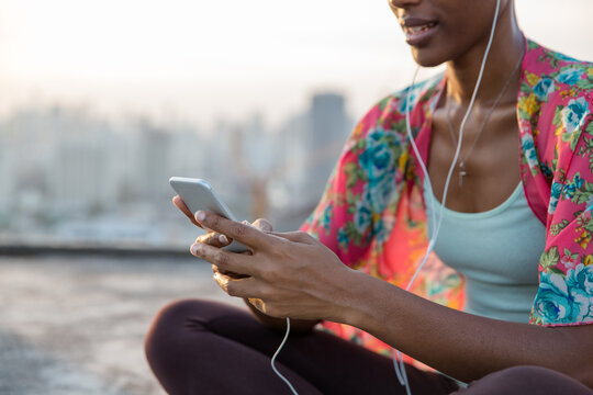 Portrait of a beautiful African American woman listening to the music