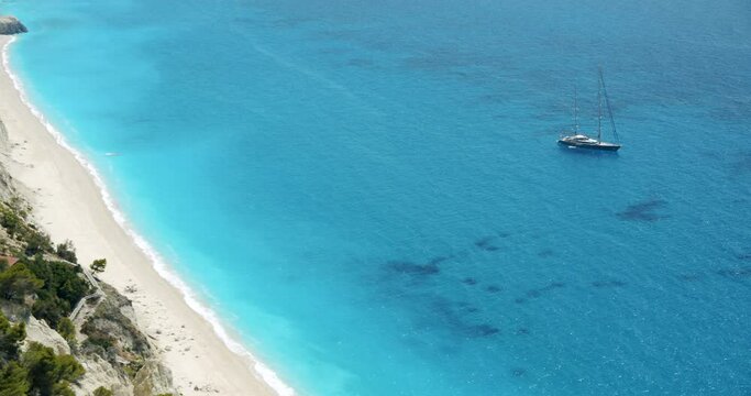 Luxury sail yacht boat in turquoise blue sea lagoon near Egremni beach, Lefkada island, Greece.