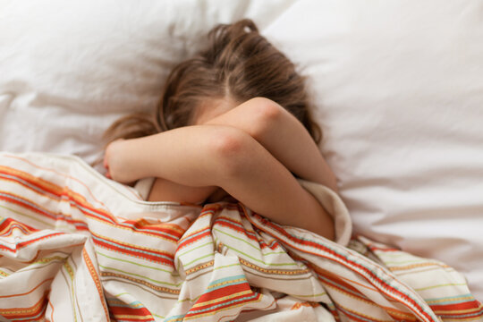 Horizontal shot of child not wanting to wake up