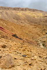 Deserted rocky slope of the crater with multi-colored stones.