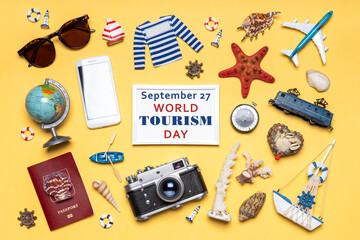 Happy world tourism day. Touristic objects, smartphone, passport, camera, sunglasses and decorative items on light background. Flat lay, top view. White photoframe, text September 27 WORLD TOURISM DAY