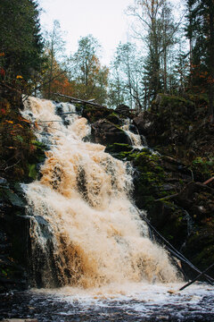 Waterfall with orange water in the forest