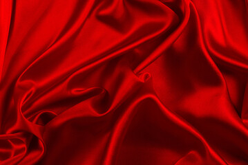 Red silk or satin luxury fabric texture can use as abstract background. Top view.